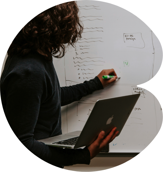 Image of a woman using a computer and a board